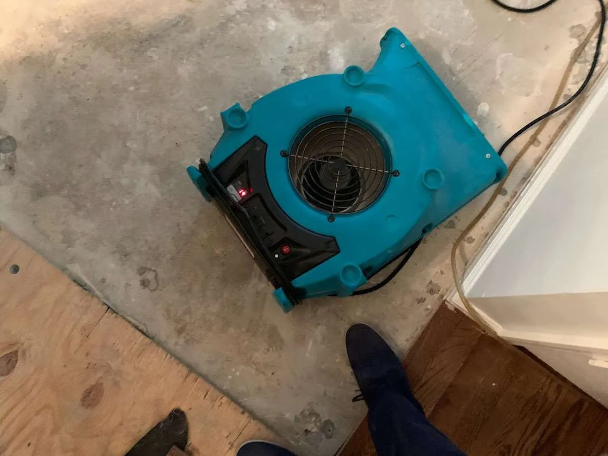 Air mover drying subfloor during Commercial Water Damage Restoration in Griswold